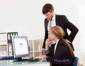 Business man and woman using a computer to search online